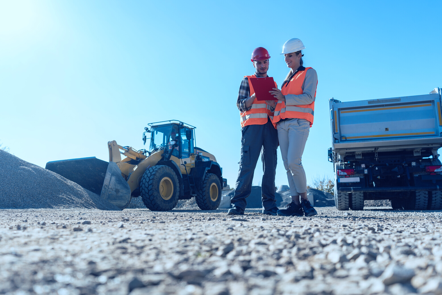 Worker and Engineer on Earthworks Construction Site Planning